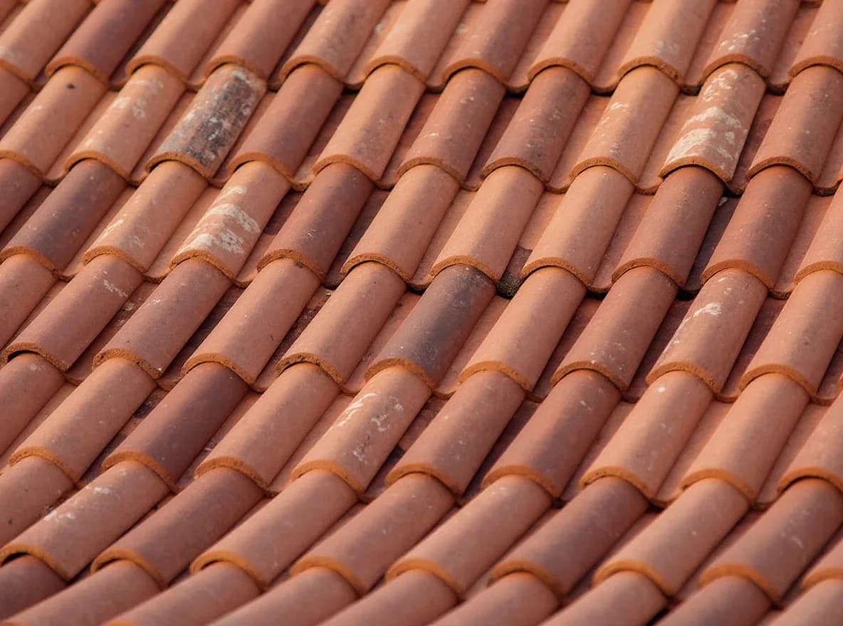 Restored terracotta tile roof in clean even courses