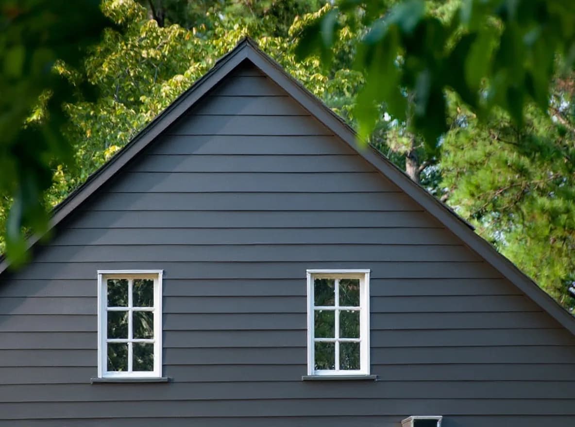 Modern dark-gray siding after the full re-side